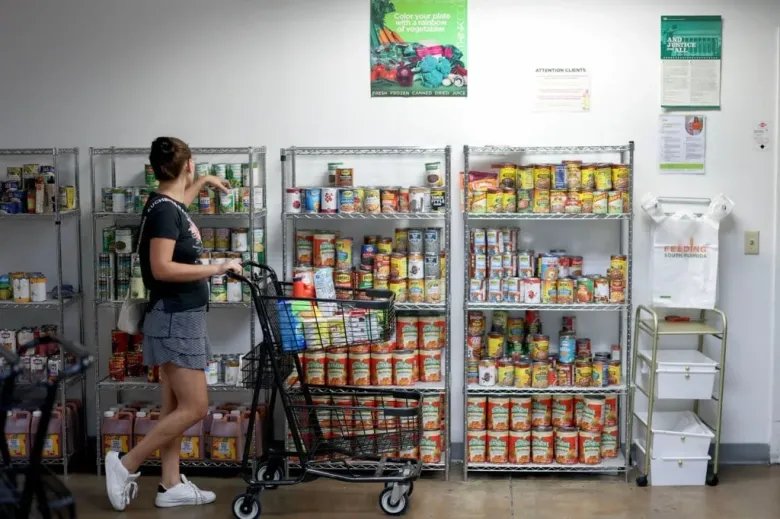 A woman shops at the Feeding South Florida food pantry in Pembroke Park Florida